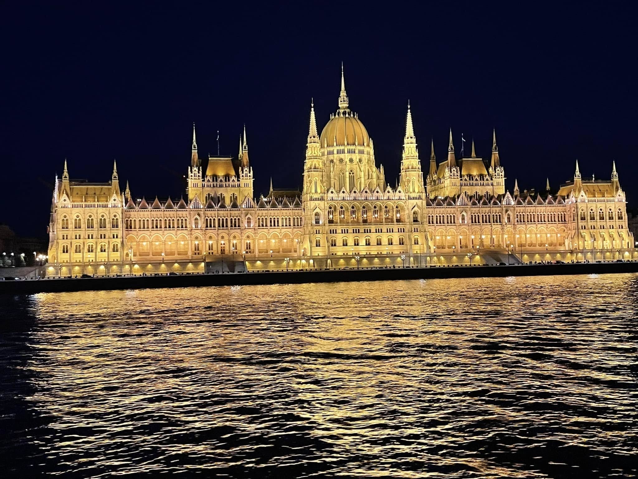 Hungarian Parliament Building illuminated at night along the Danube River on Tauck River Cruise