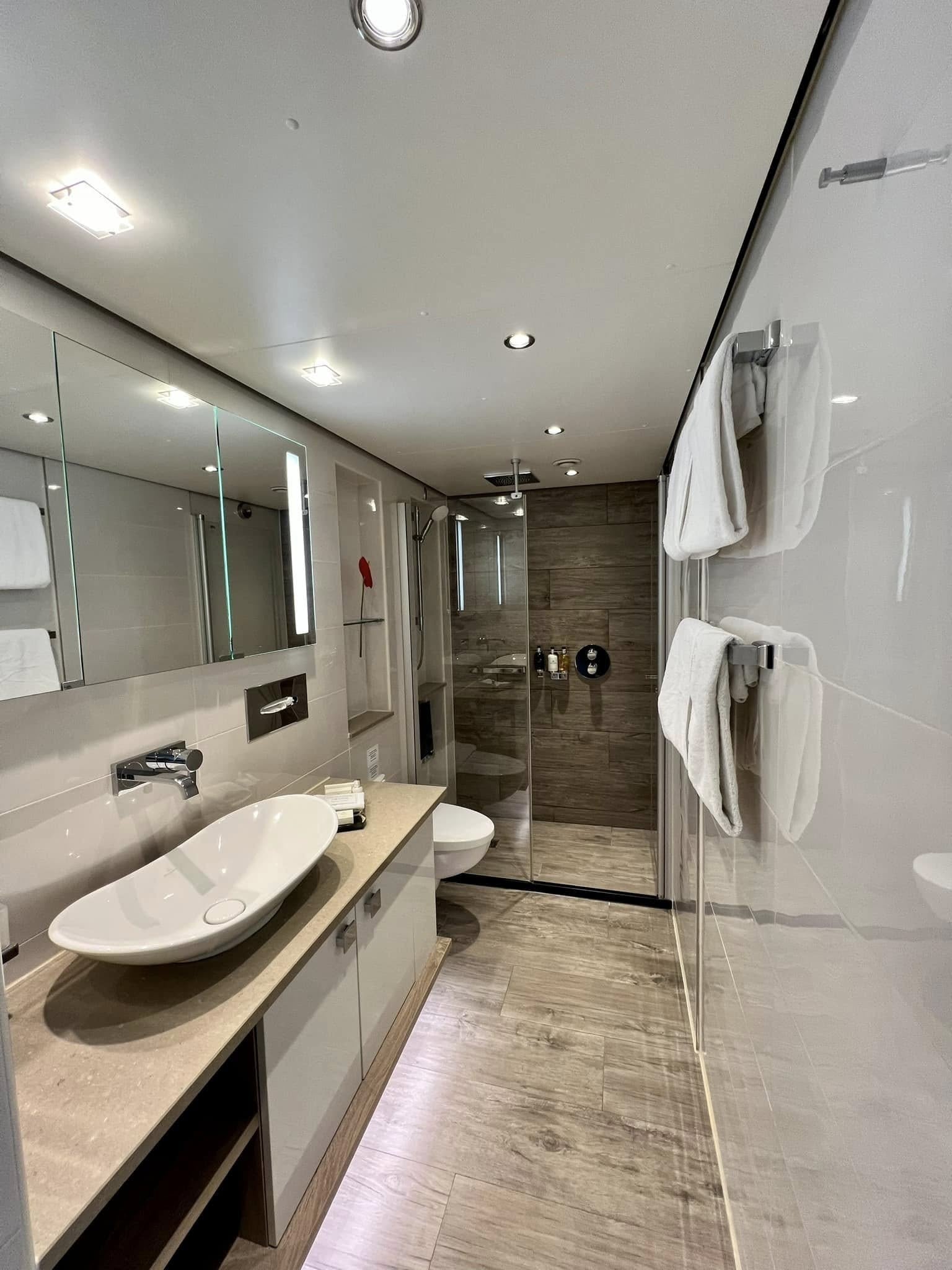 Tauck Suite Marble Bathroom with Dual Vanities and Rain Shower