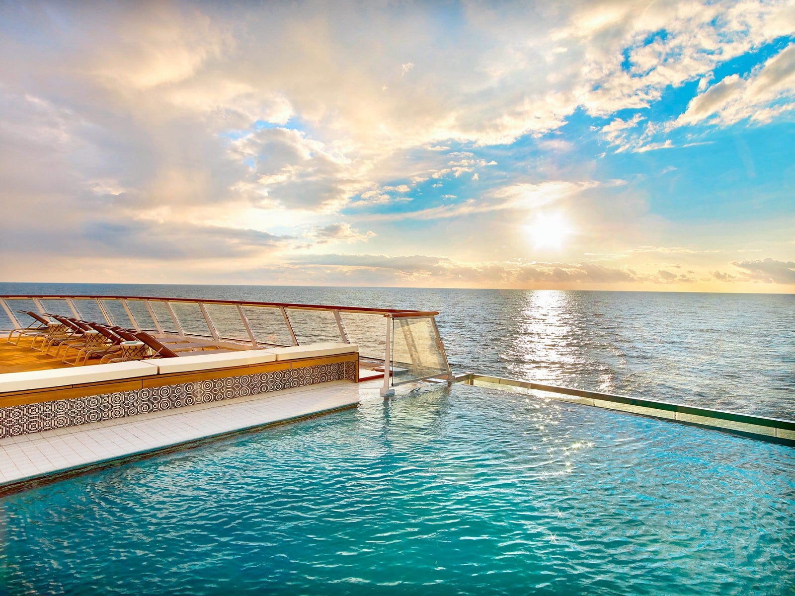Viking ocean cruise glass infinity pool overlooking the ocean horizon at sunset