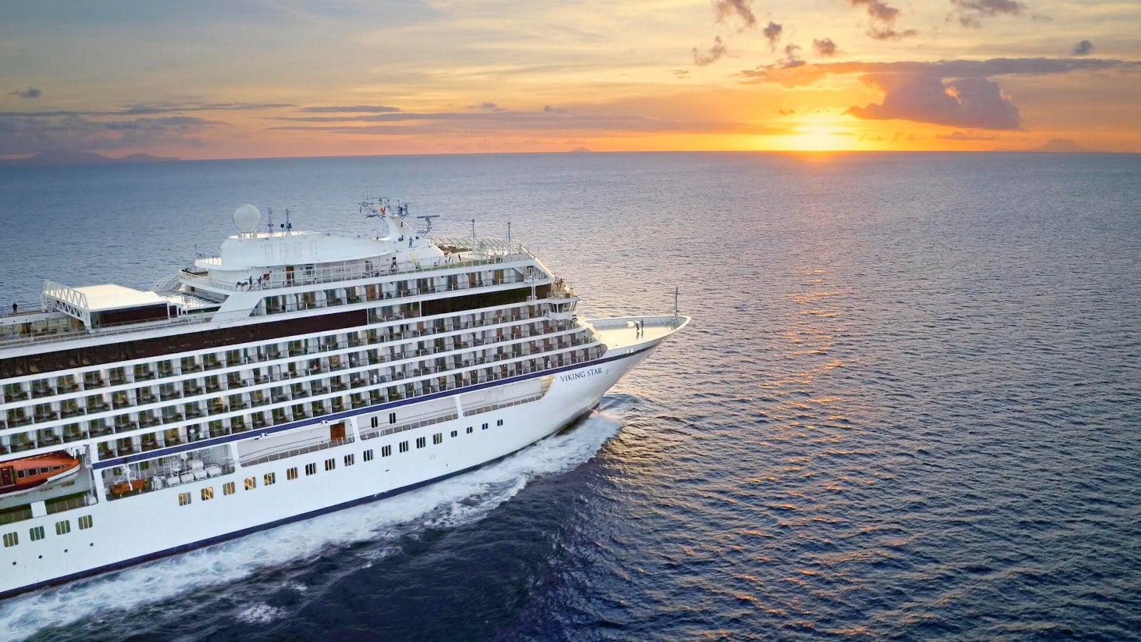 Viking ocean cruise ship sailing at sunset on an around-the-world voyage