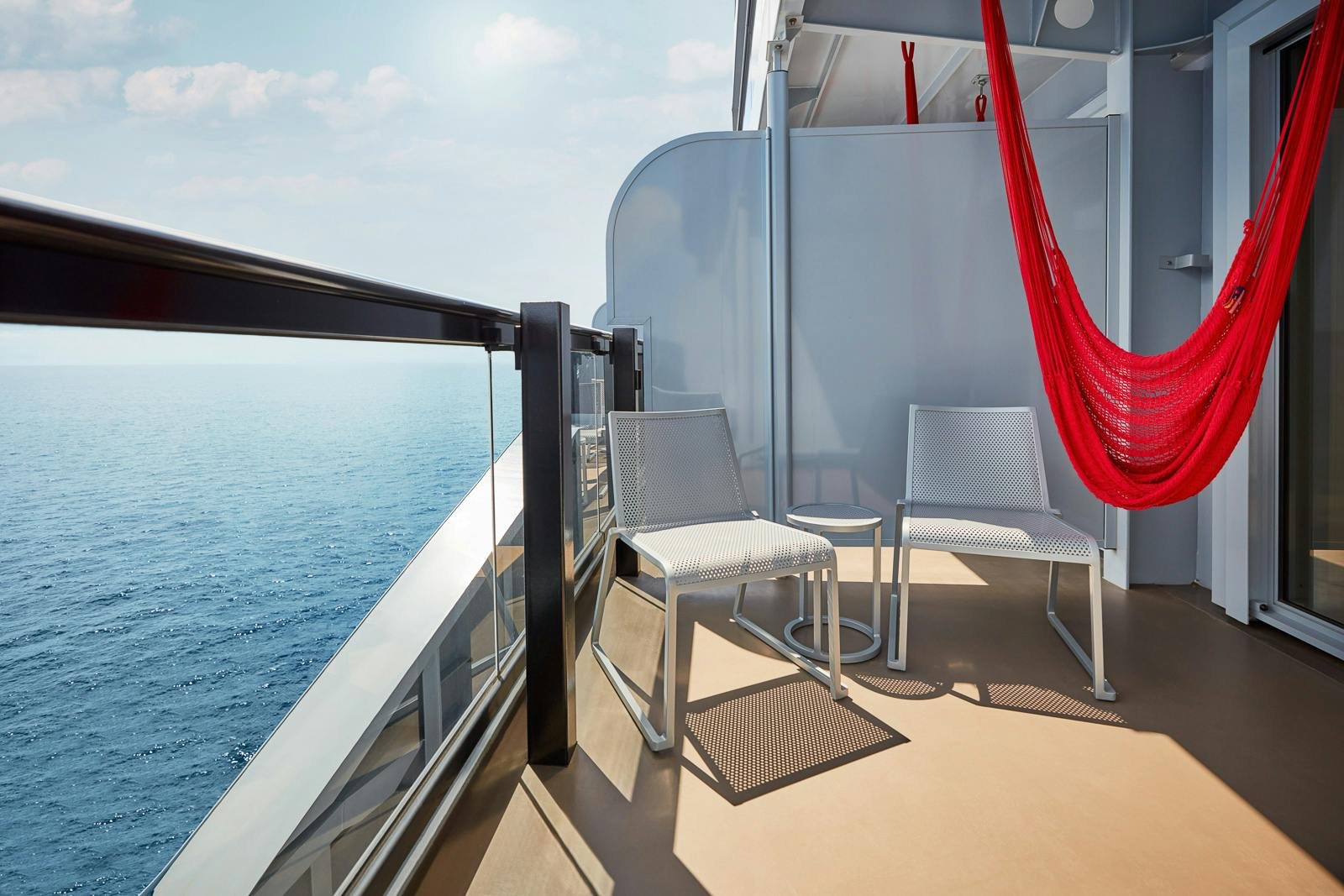 Virgin Voyages Sea Terrace balcony cabin featuring signature hand-woven red hammock