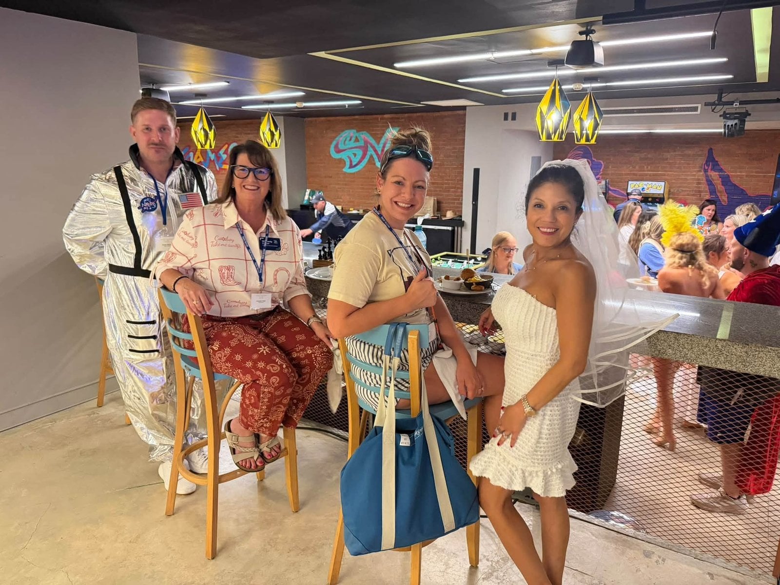 Astronaut, bride, and safari explorer costumes at the retro childhood career party