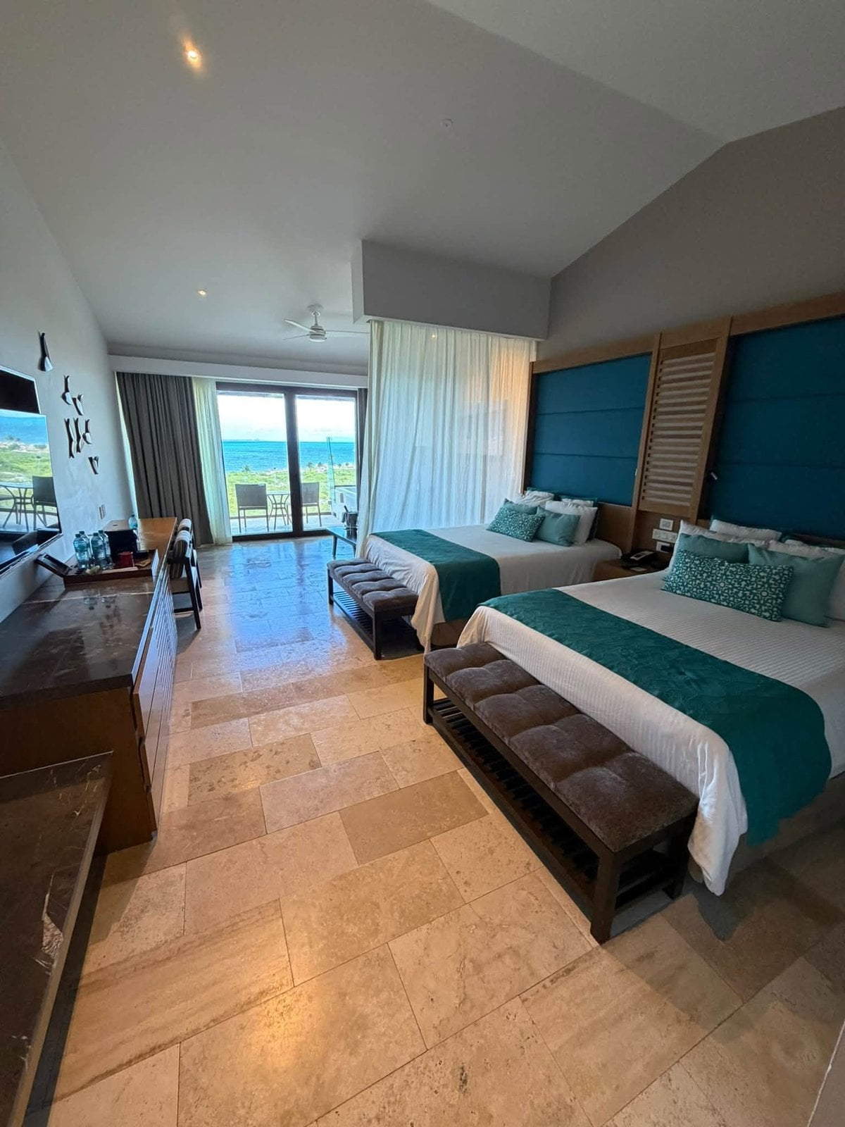 Preferred Club luxury suite interior with double queen beds and ocean terrace at Dreams Playa Mujeres