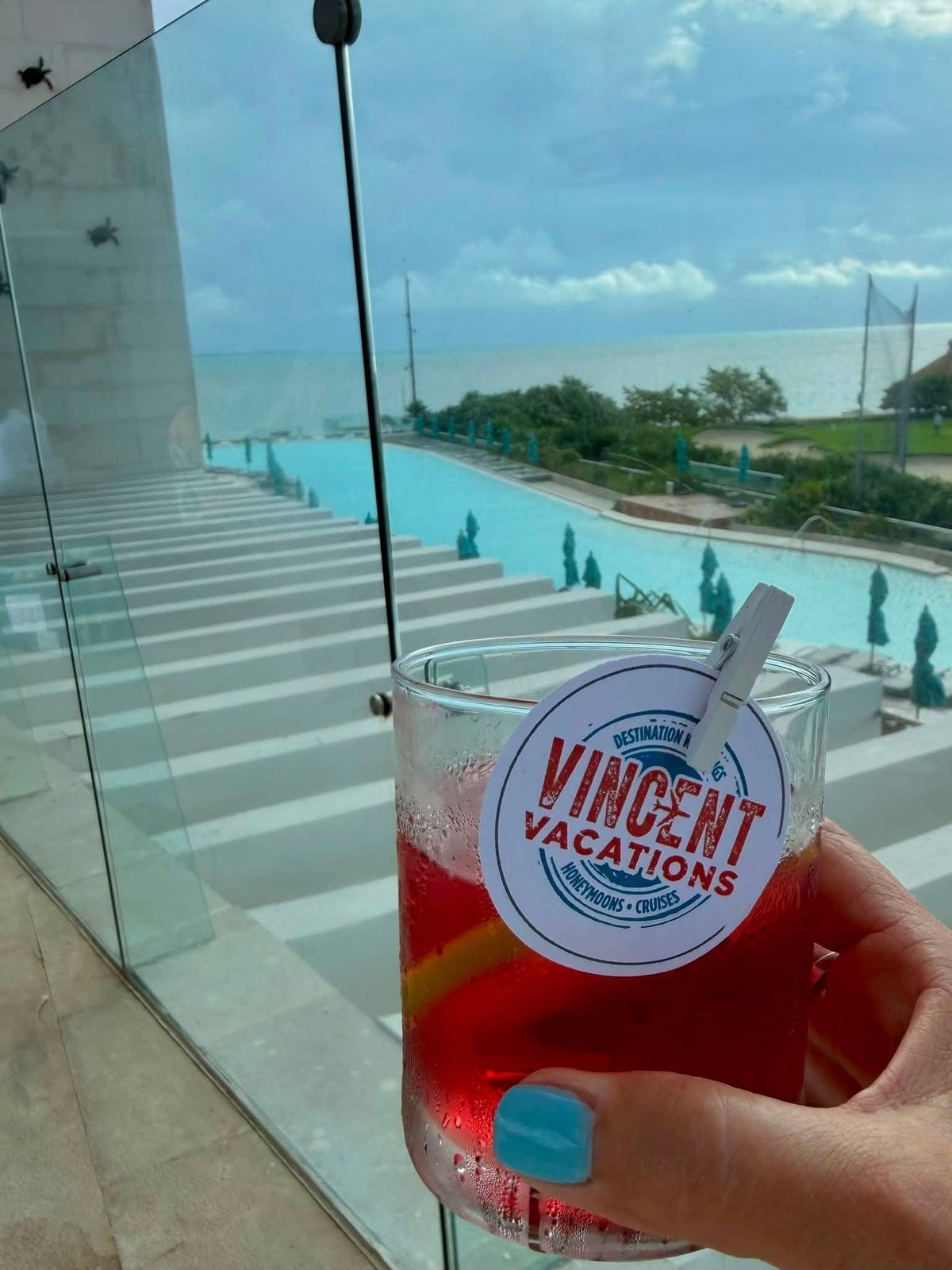 Private swim-out balcony overlooking turquoise ocean with Vincent Vacations custom cocktail