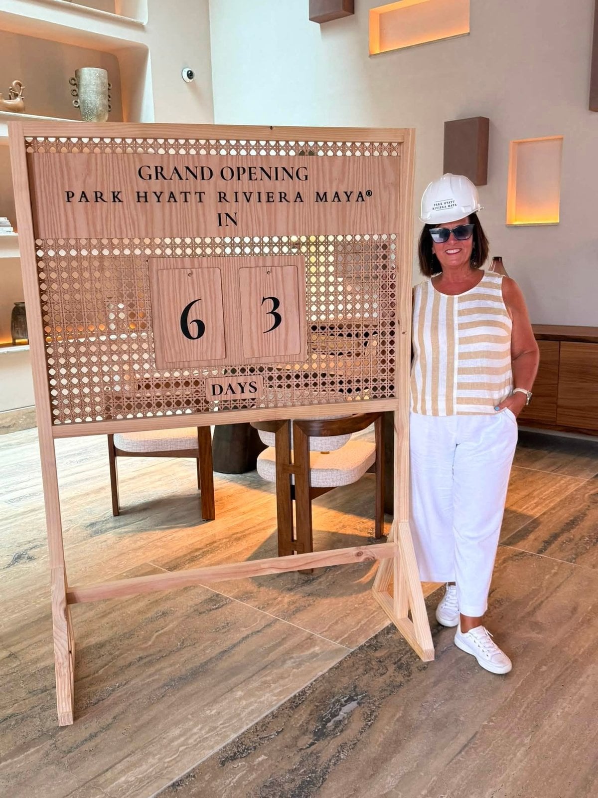 Park Hyatt Riviera Maya grand opening countdown sign showing 63 days until opening with advisor in hardhat