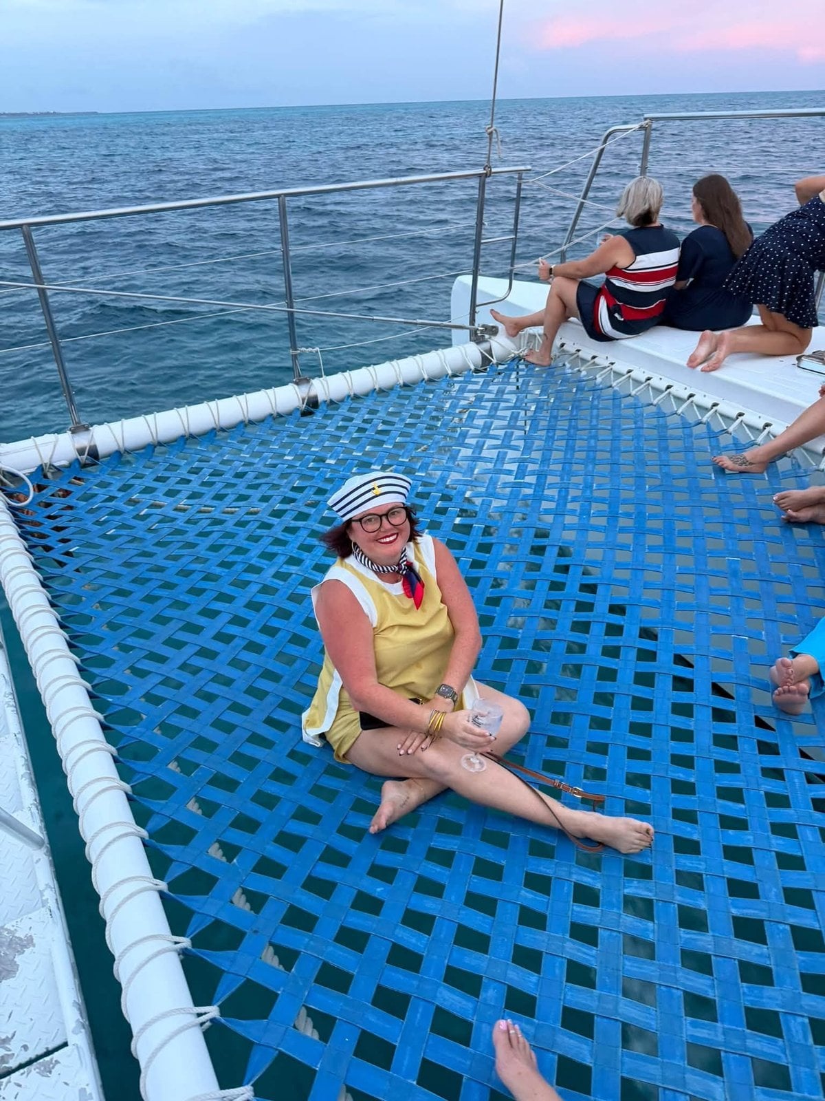 Lounging over the turquoise sea waves on the catamaran forward netting