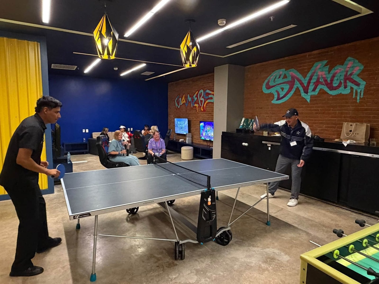 Travel advisors enjoying friendly competition in the resort entertainment and sports lounge