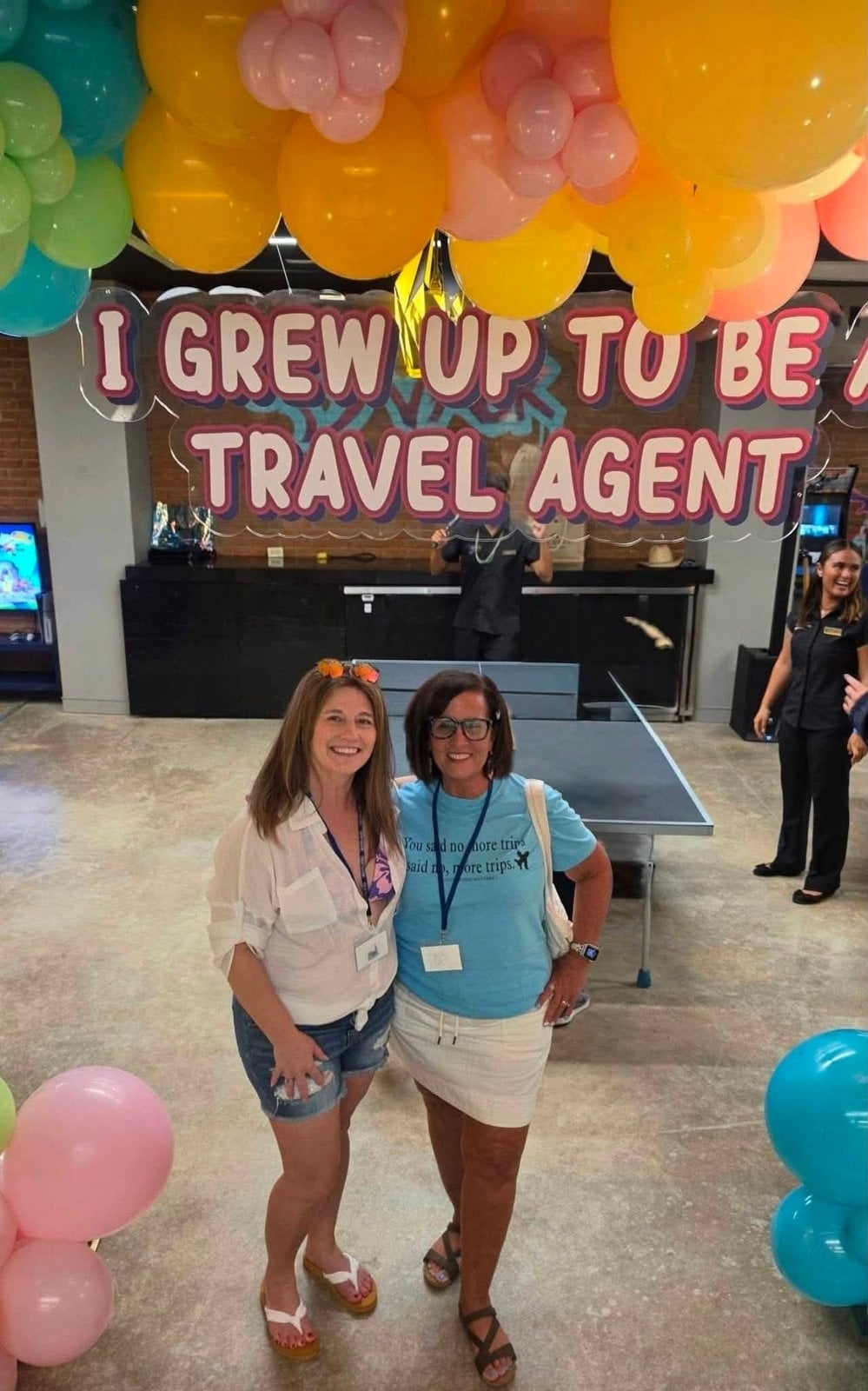 Lia Vincent kicking off the retreat under the When I Grow Up To Be A Travel Agent party arch