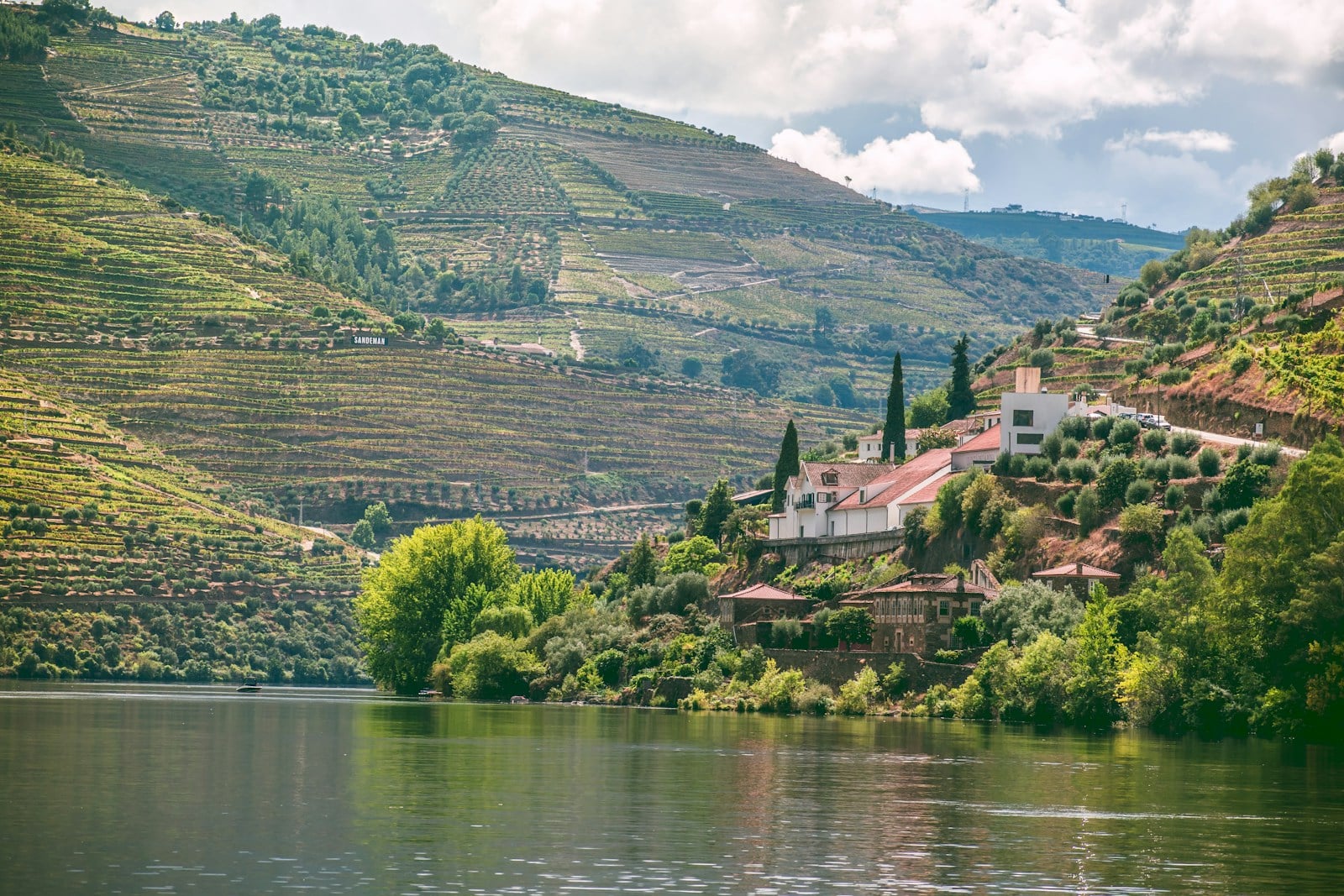 Tauck MS Andorinha luxury river cruise sailing past terraced vineyards along the Douro River in Portugal