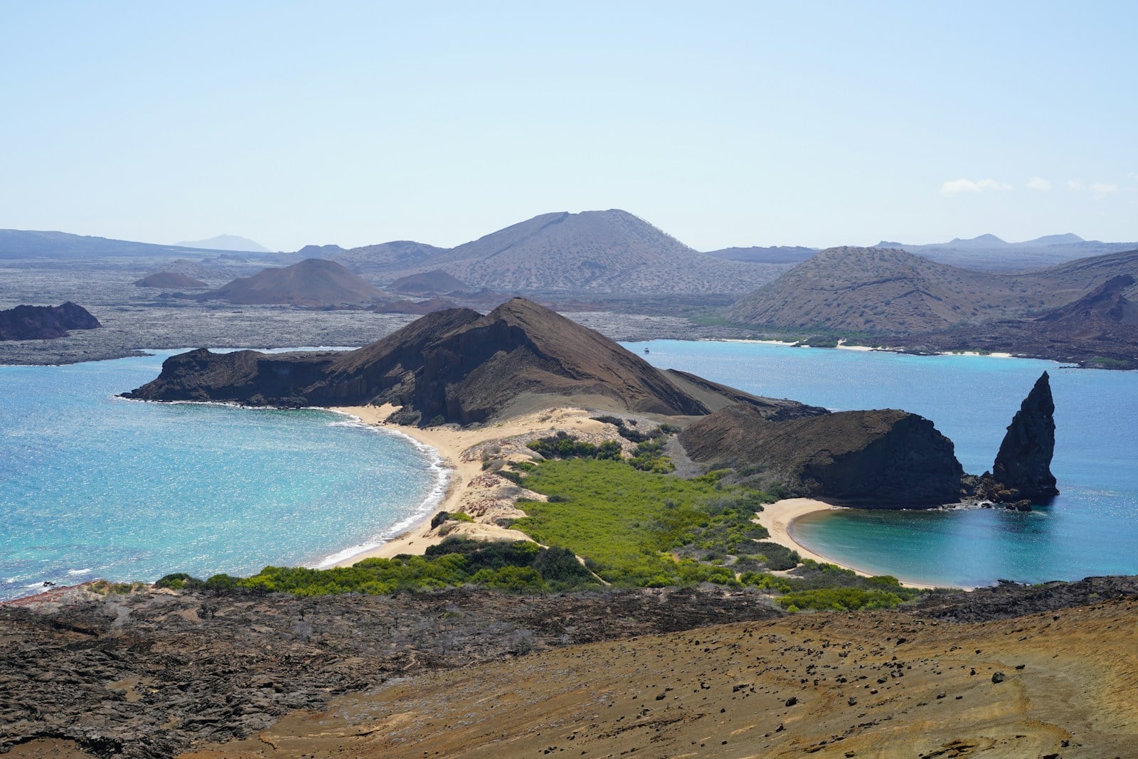 Tauck Galapagos luxury expedition yacht sailing near volcanic islands with giant tortoises and marine iguanas