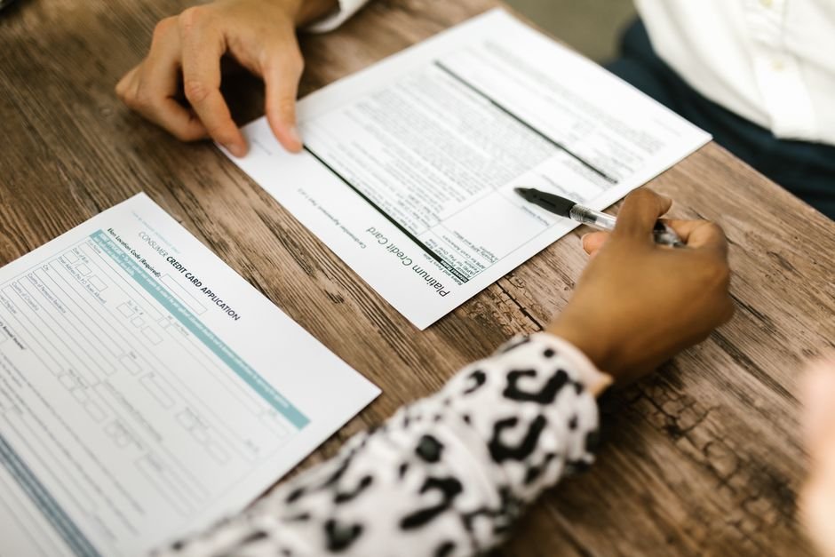 Advisor reviewing written credit card authorization form and transaction records