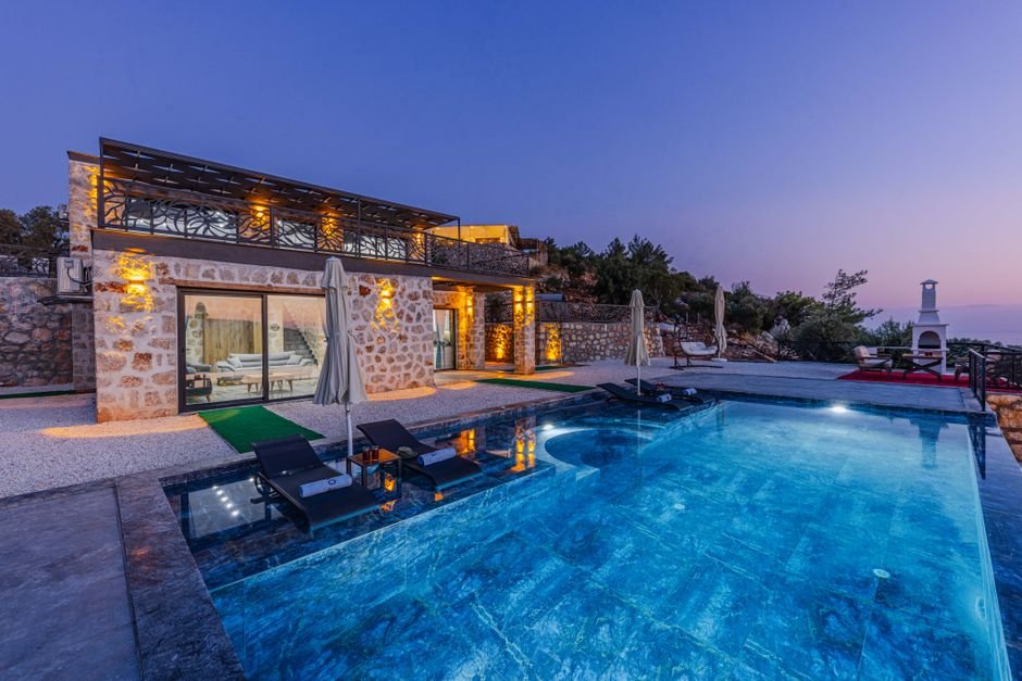 Delighted luxury travel clients celebrating milestone anniversary in private infinity pool villa