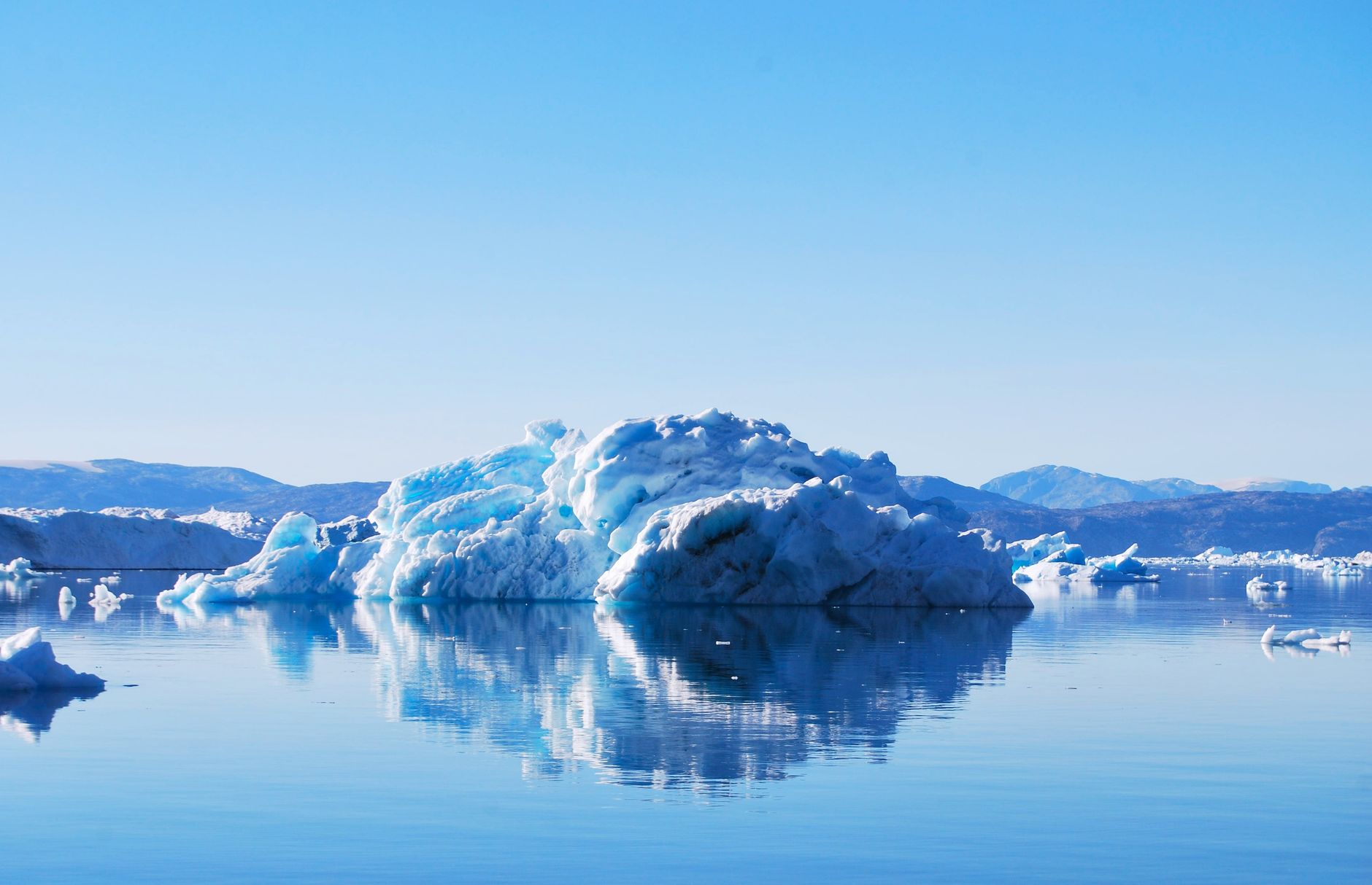 Dramatic Massive Blue Iceberg in Greenland Fjord with Luxury Expedition Ship