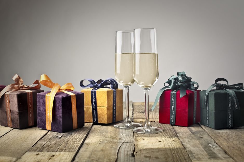 Luxury curated client welcome home gift box with champagne and handwritten card on elegant table