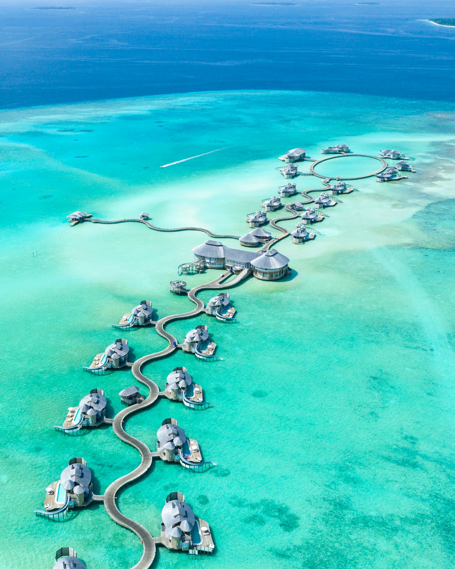Maldives private island resort with turquoise lagoon and luxury overwater villas
