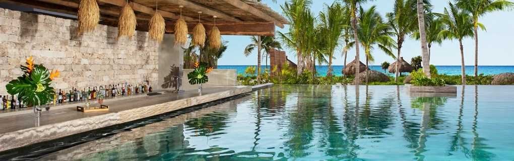 Secrets Resorts beachfront candlelit dinner setup on white sand