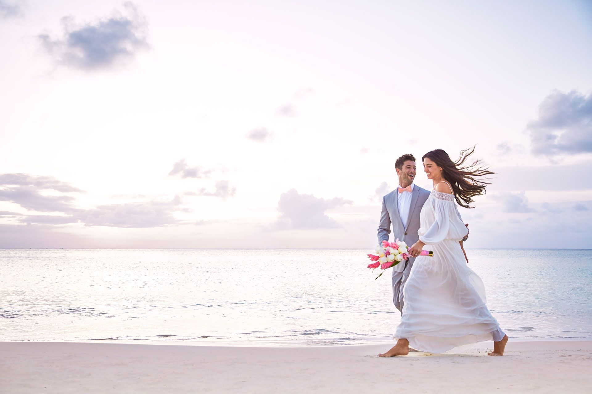 couple walking on beach in antigua