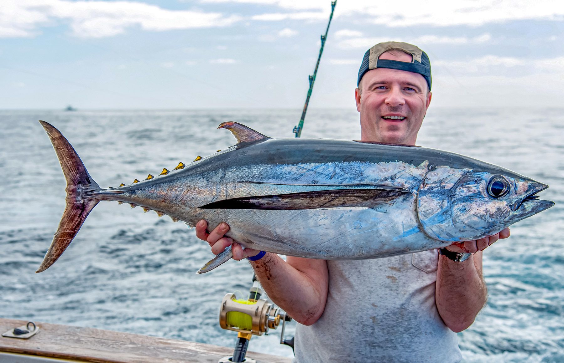angler fisherman holding blackfin tuna