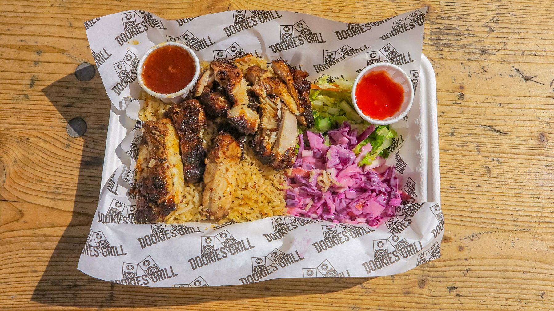 Street food jerk chicken with hot sauce