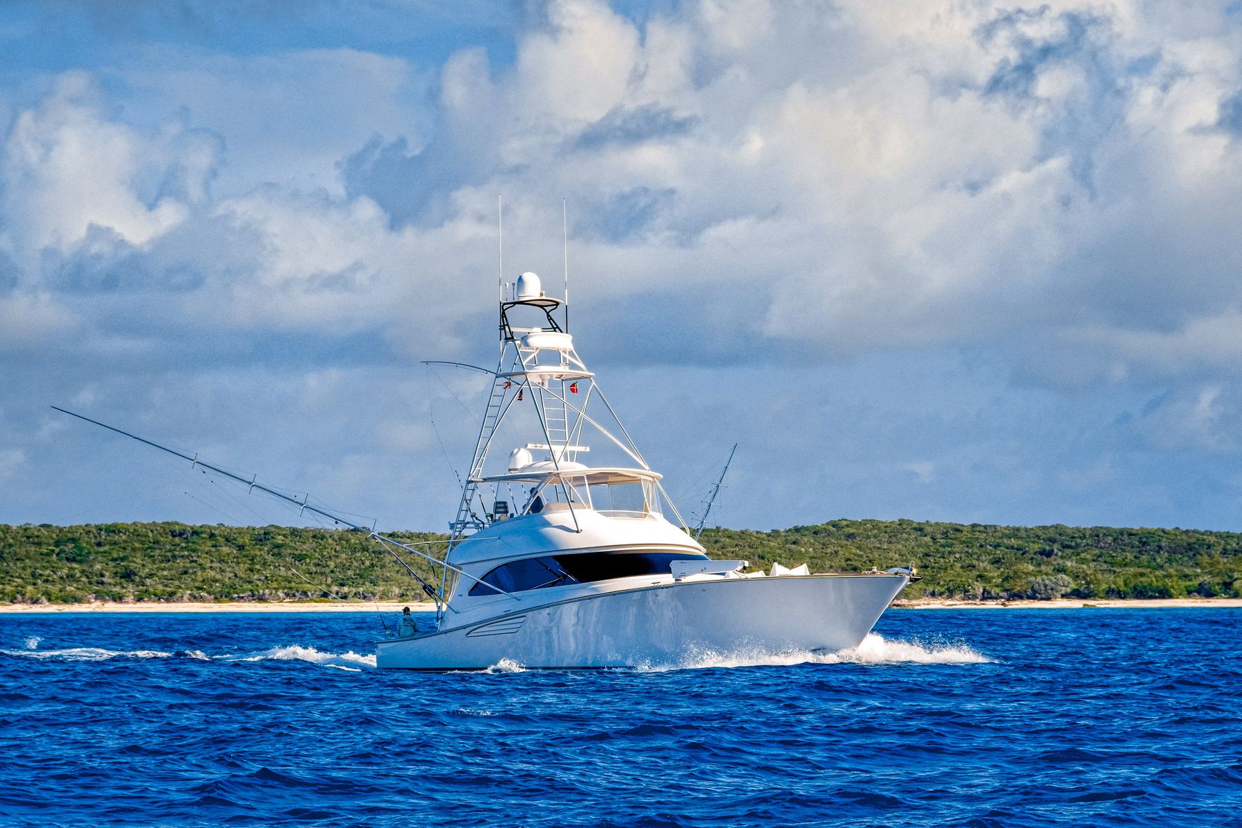 fishing boat cruising over blue water