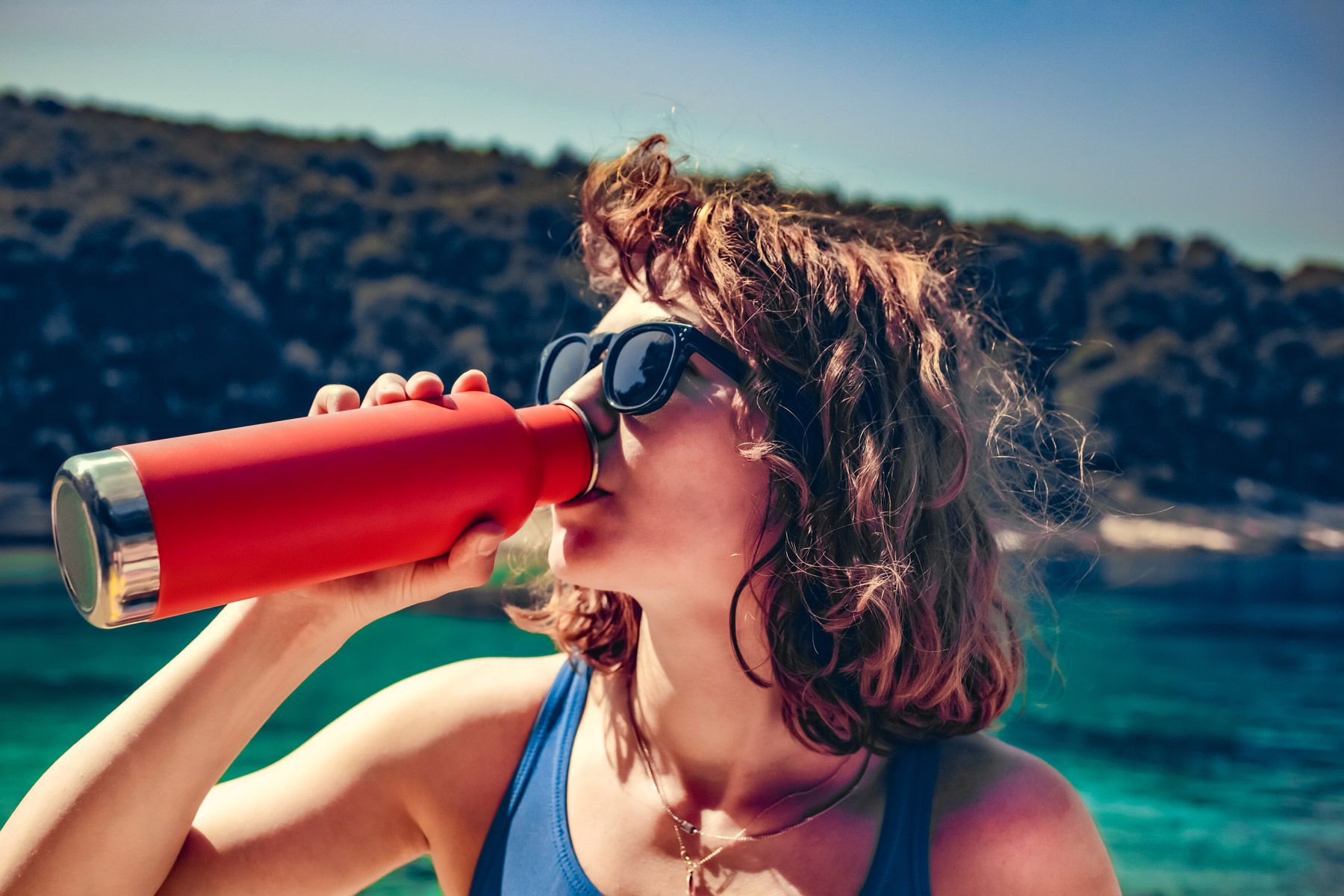 woman drinking thermo bottle
