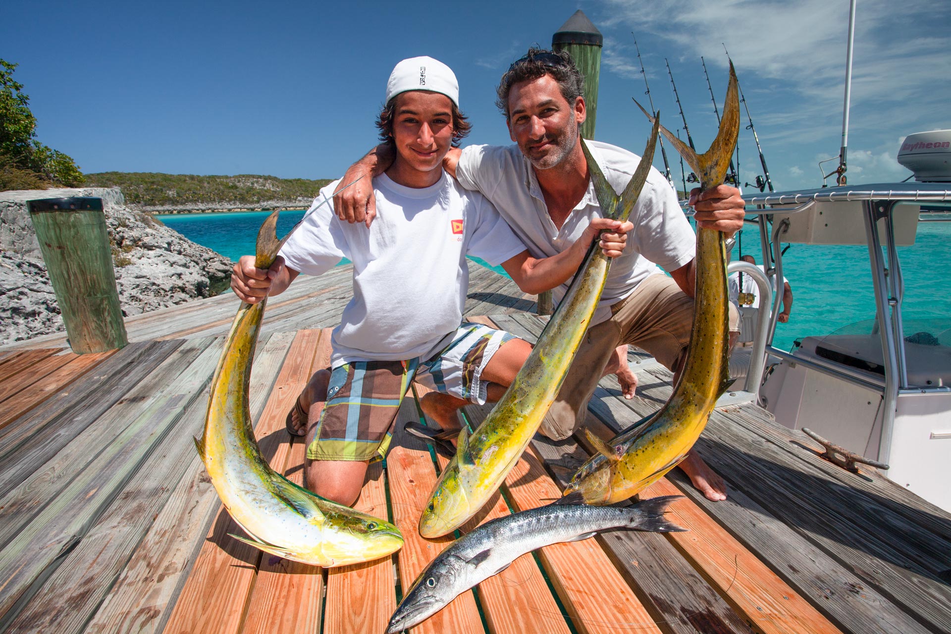 Fishermen posing with caught mahi