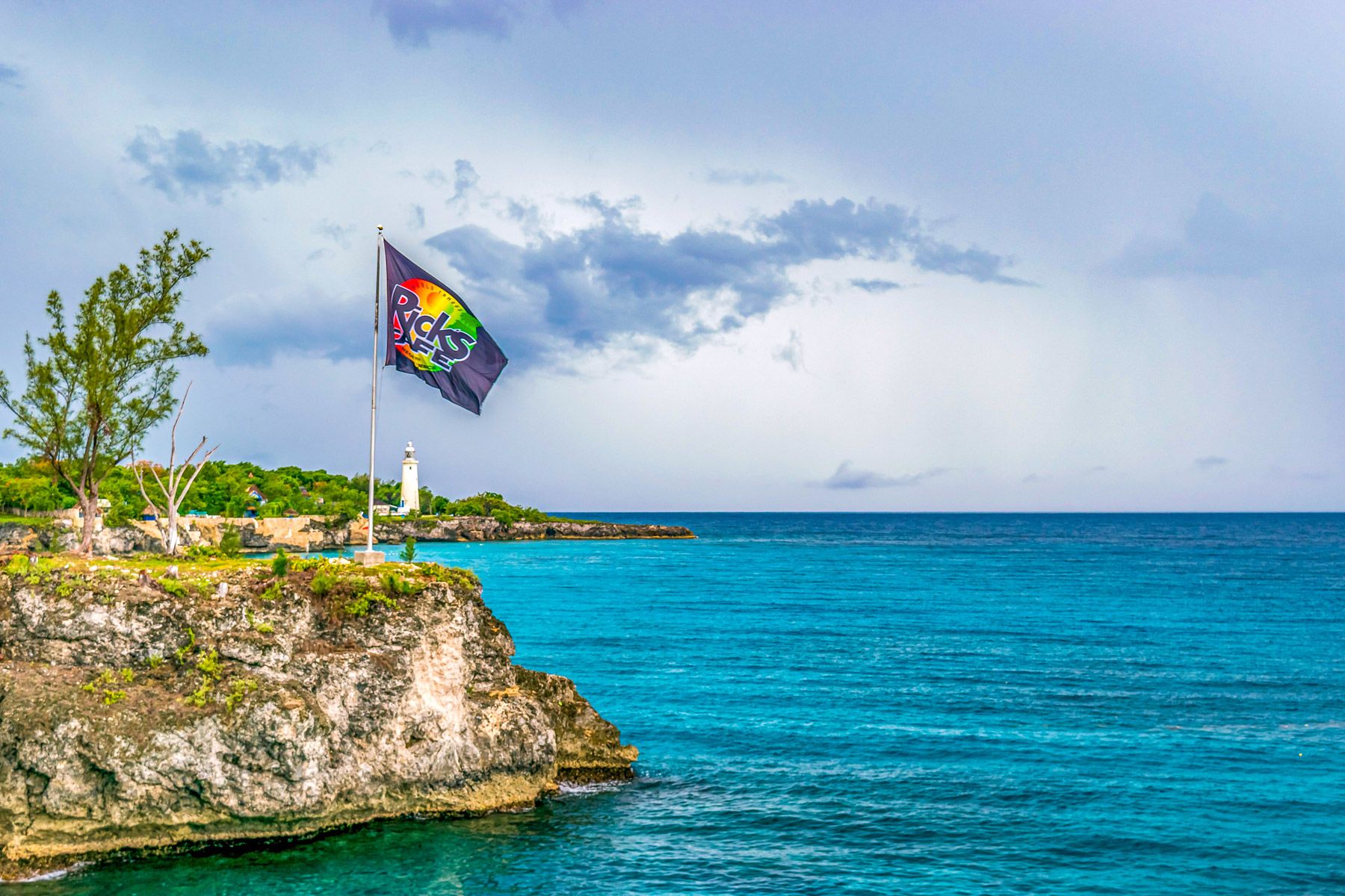 ricks cafe cliffs flag lighthouse negril jamaica