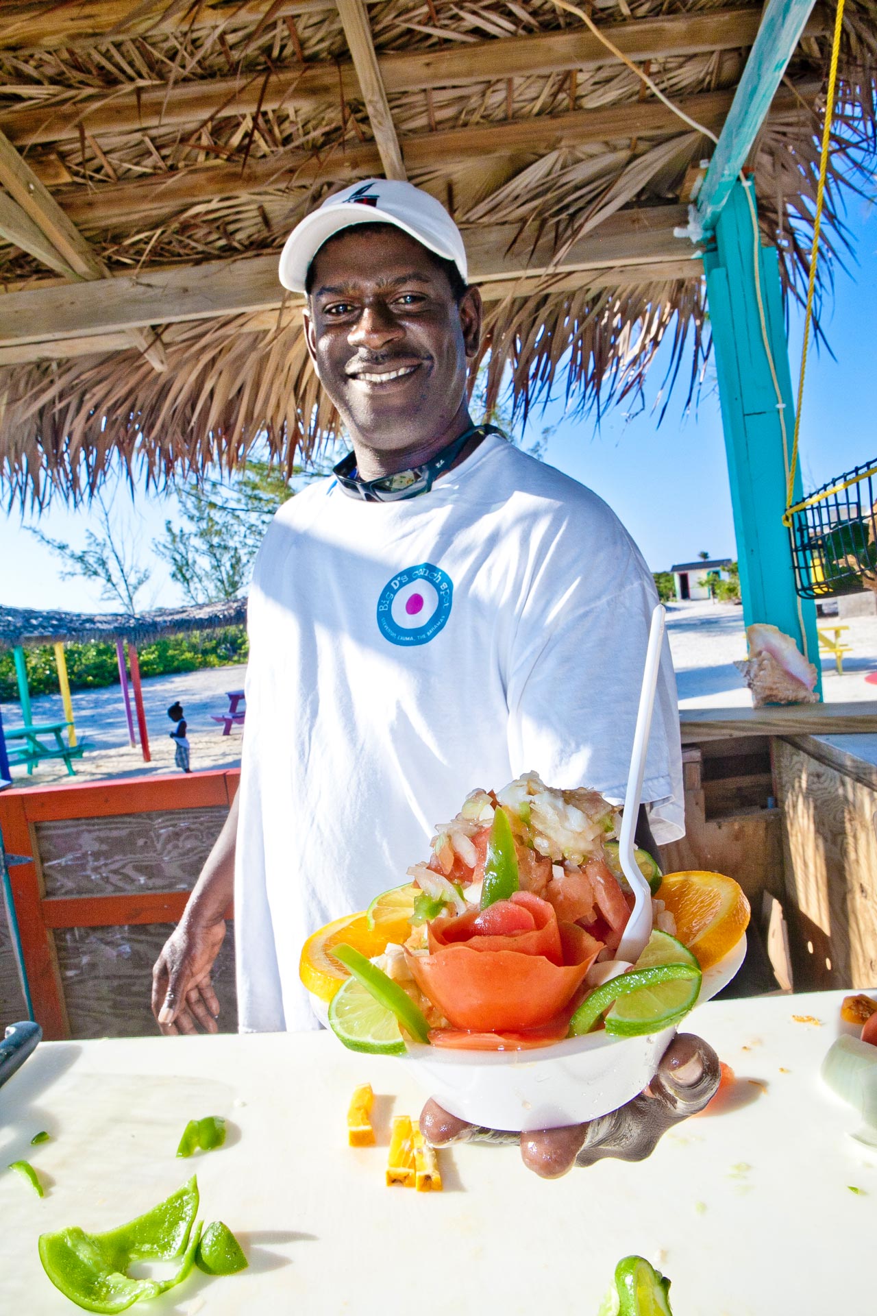 A Bahamian holding a bowl of Conch Salad