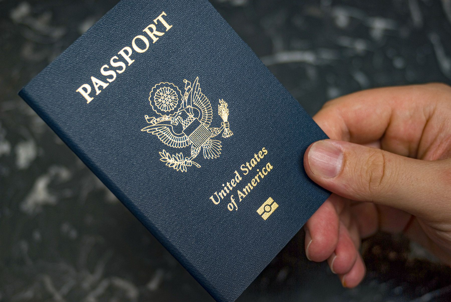 man holding U.S. passport