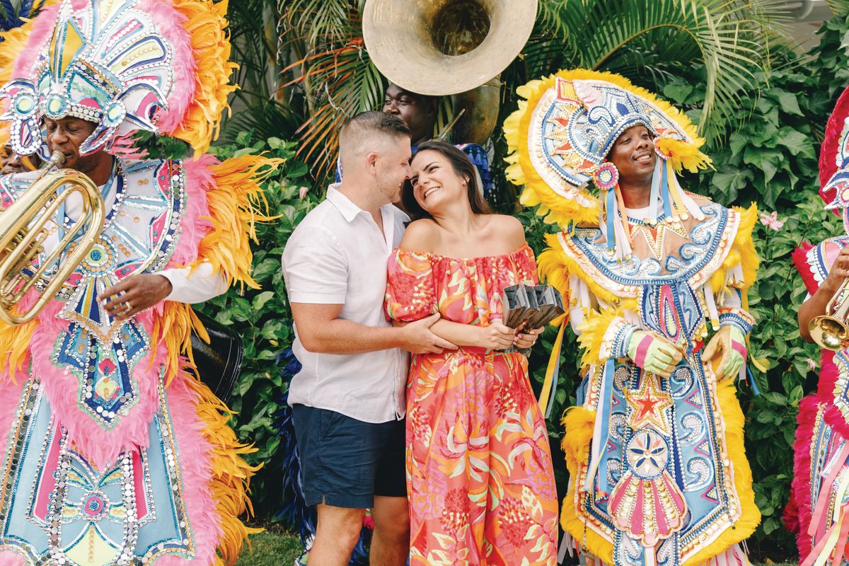 couple in nassau bahamas with junkanoo performers