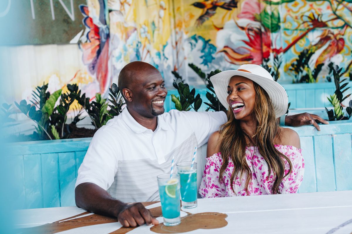 couple drinking blue cocktails in curacao