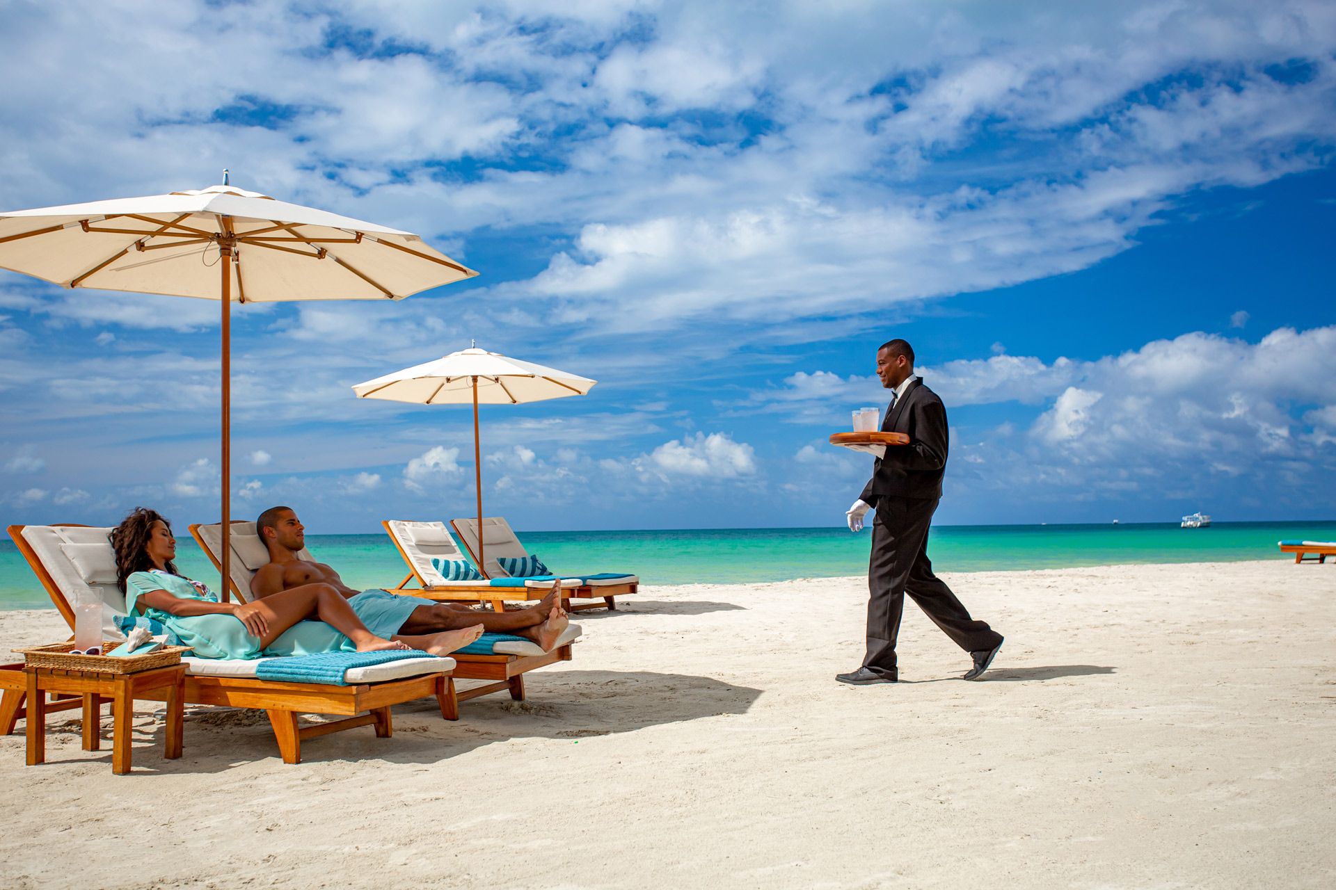 Butler serving drinks at beach