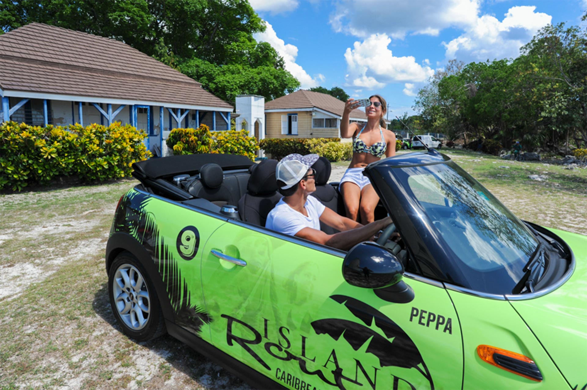 couple taking pictures on mini cooper negril tour