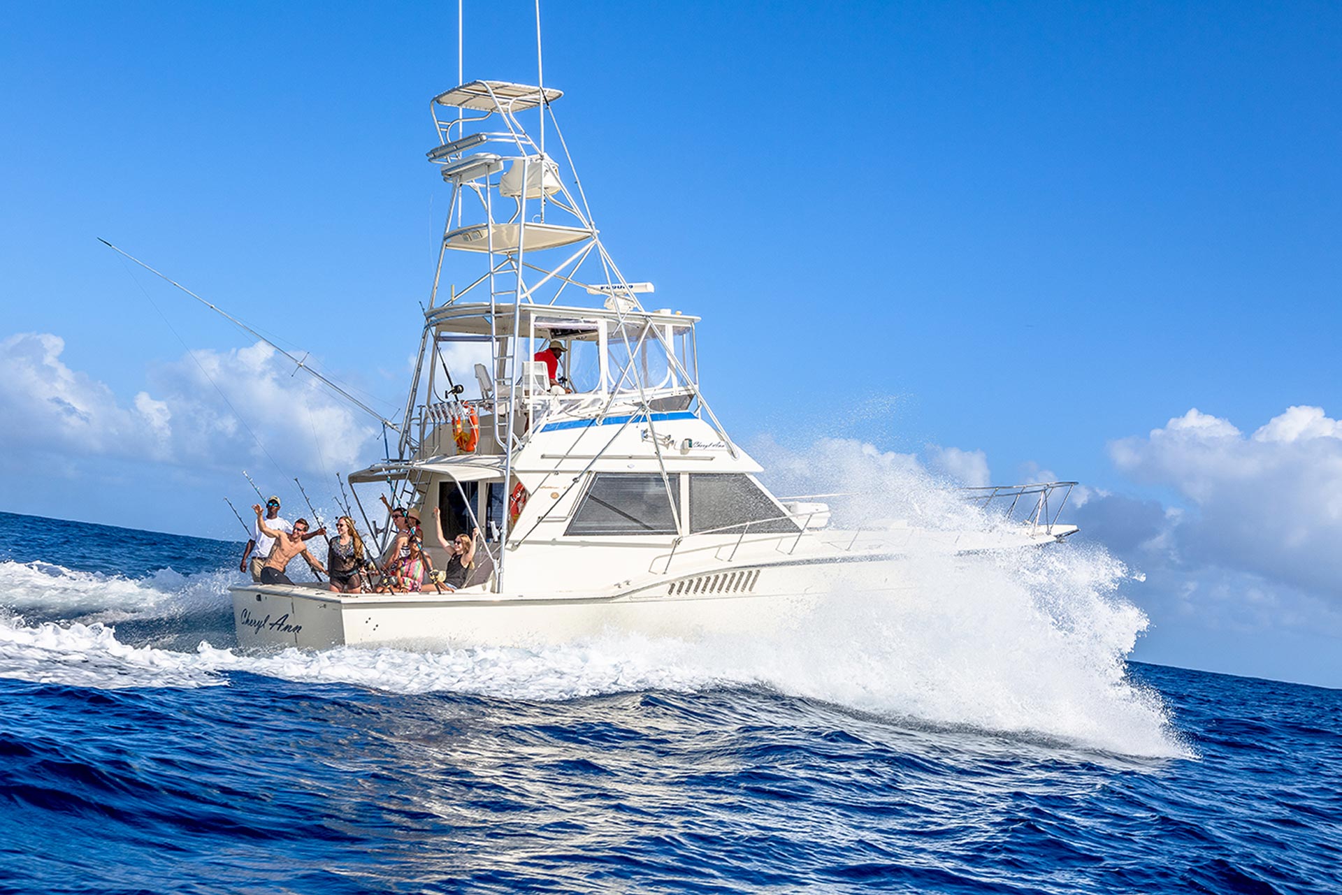 guests riding at back of fishing boat