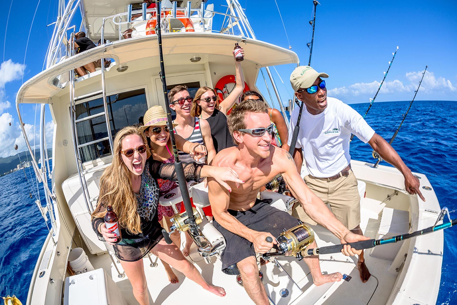 guests fishing from back of fishing boat