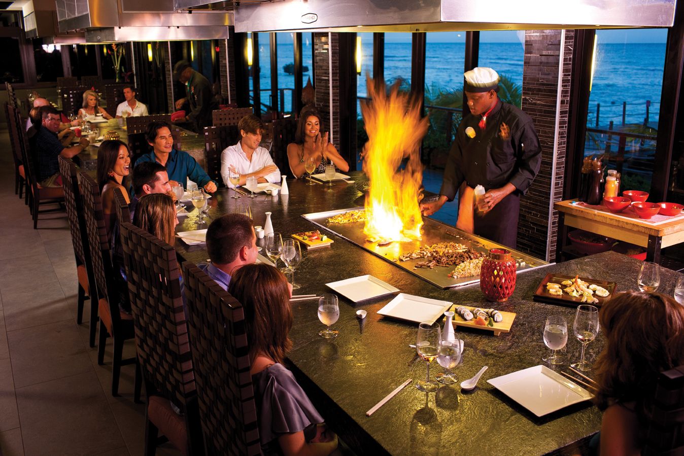 guests enjoying snd dinig at the kimonos habachi at sandals ochi