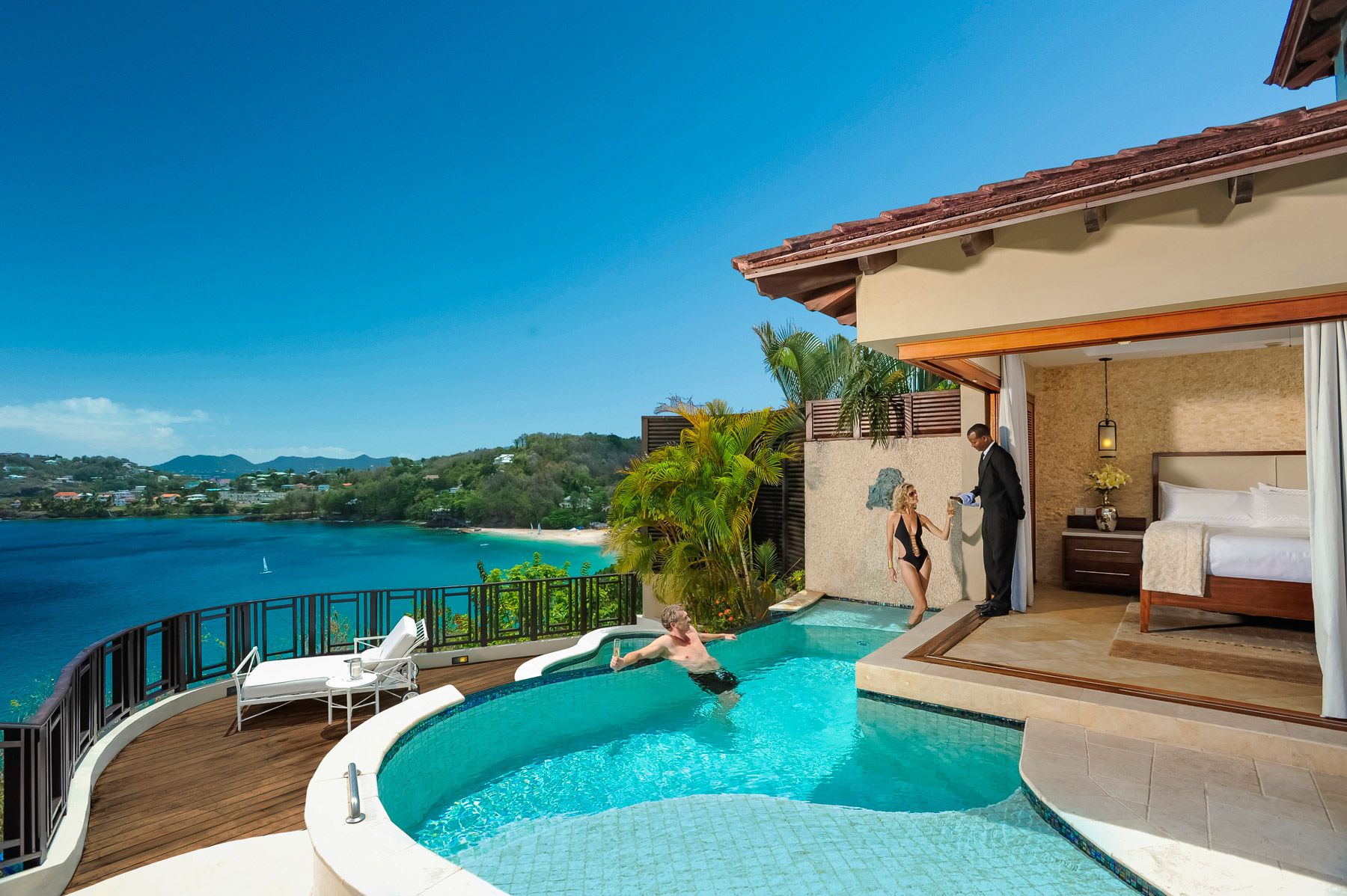 couple at the millionaire suite pool with ocean view behind them