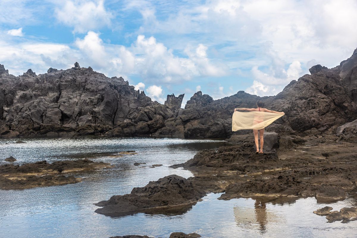 woman on a volcanic beach in st vincent