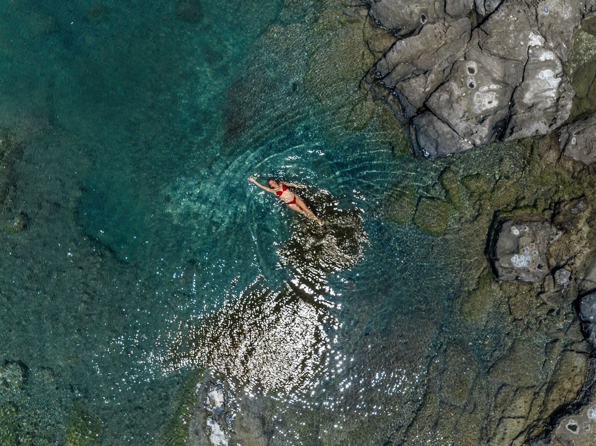 woman floating in a natural pool in Saint Vincent and the Grenadines