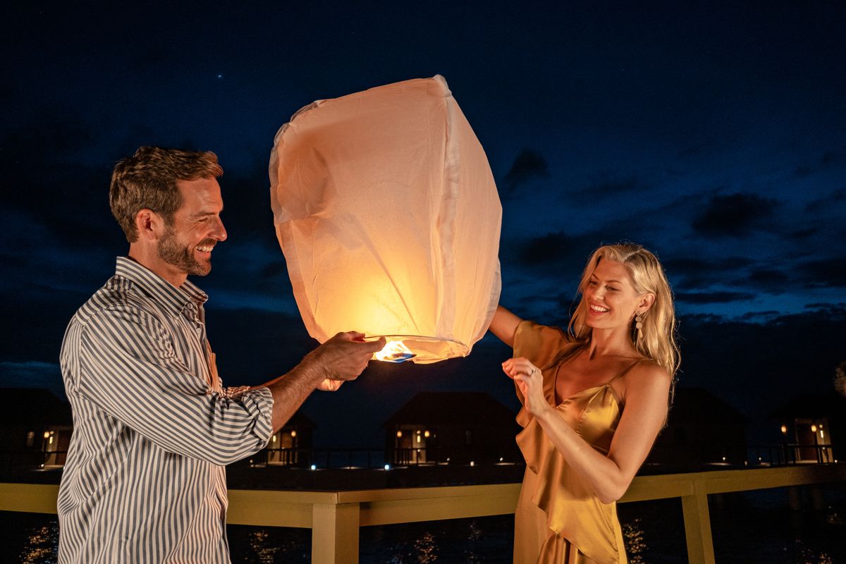 couple lighting a lantern