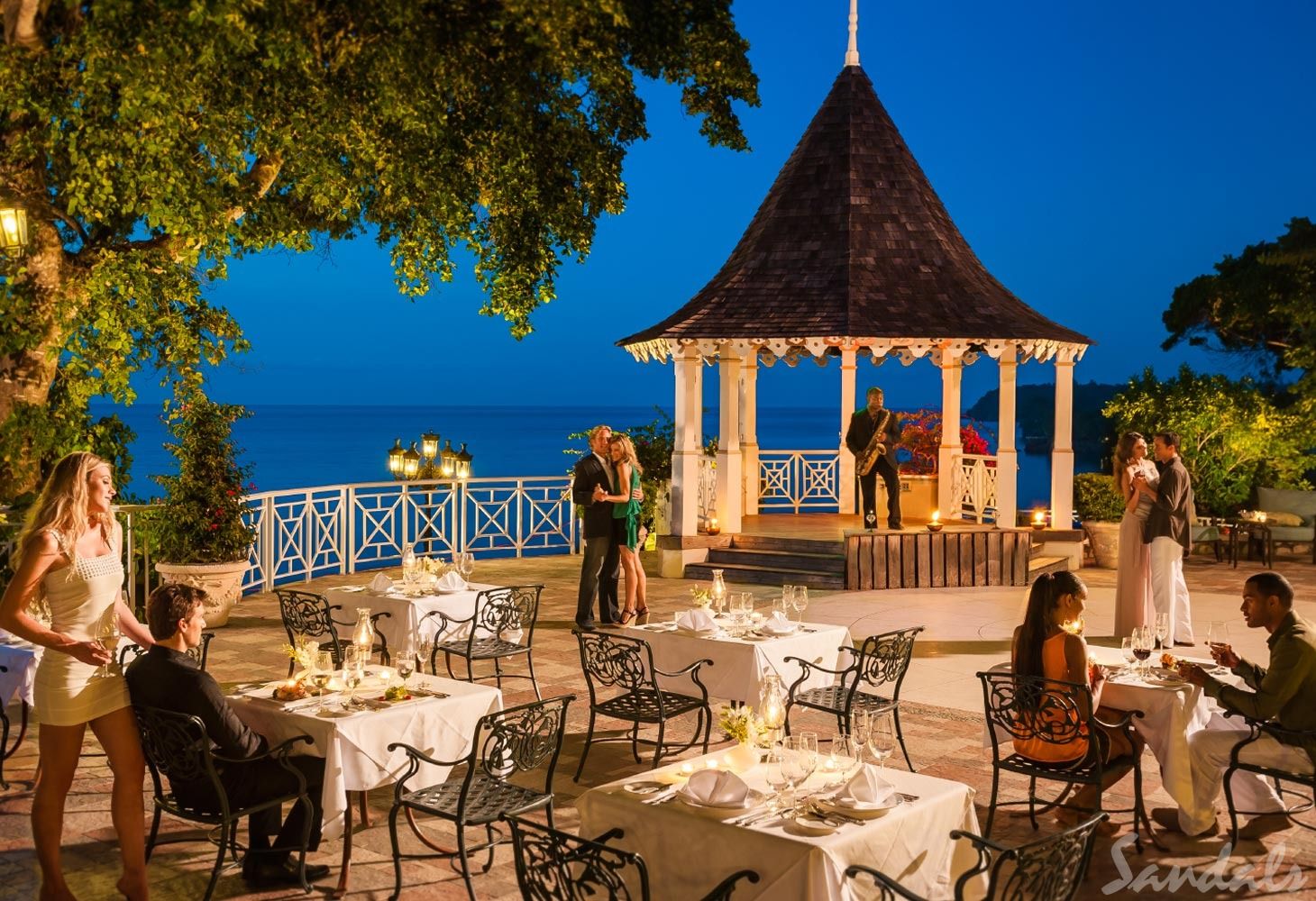 Various couples dancing and enjoying live mellow music at the patio gazebo