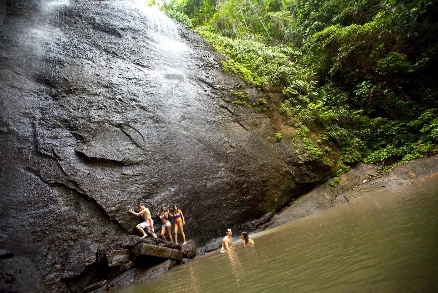 people taking a dip on errard waterfall's waters