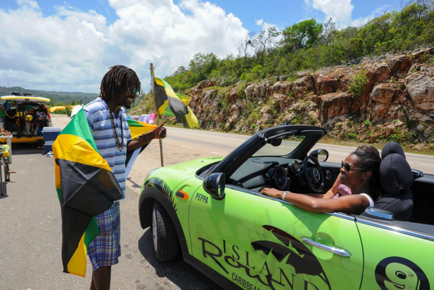 guests interacting with local while on mini cooper ocho rios tour