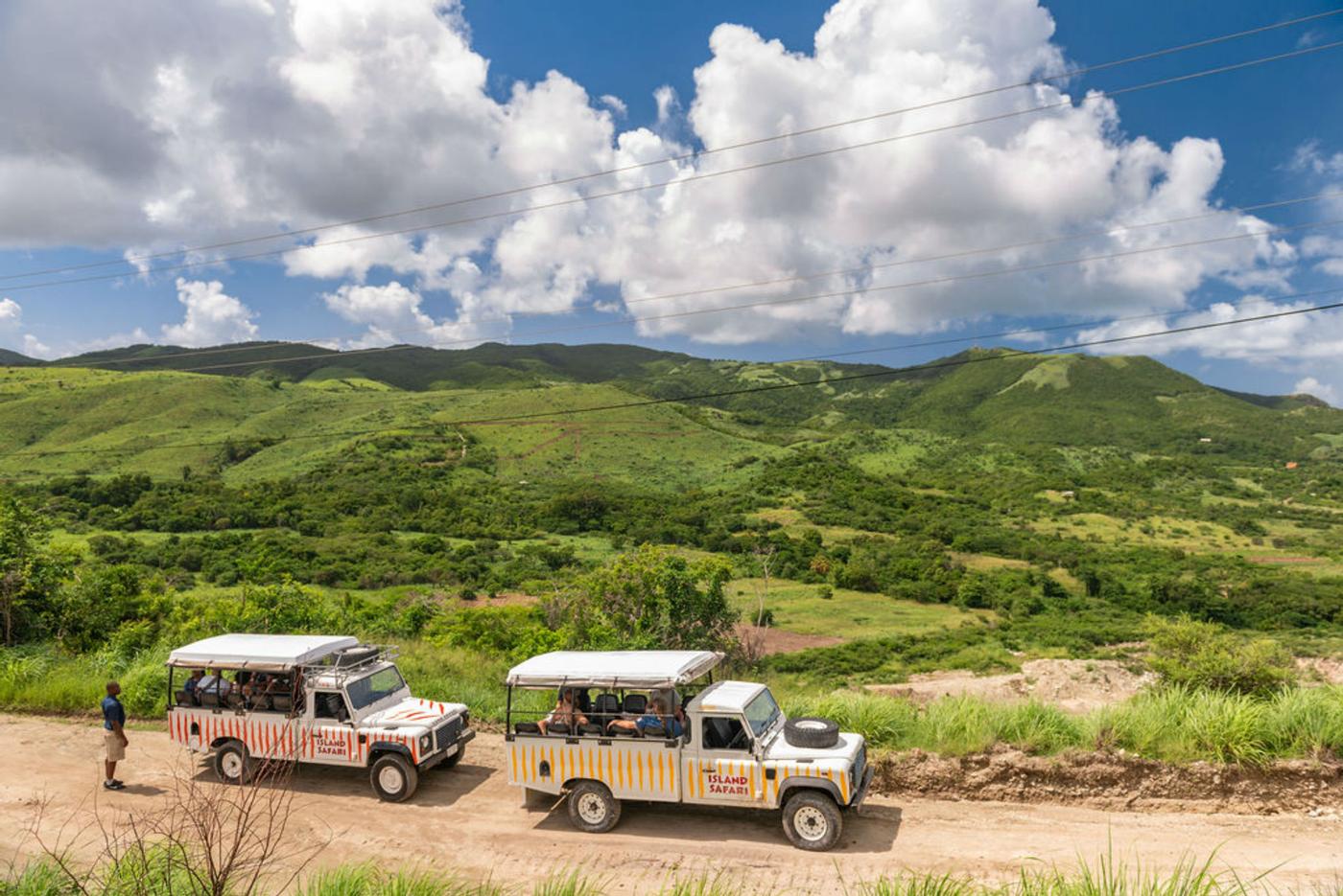safari land rovers making their ways through the island sites