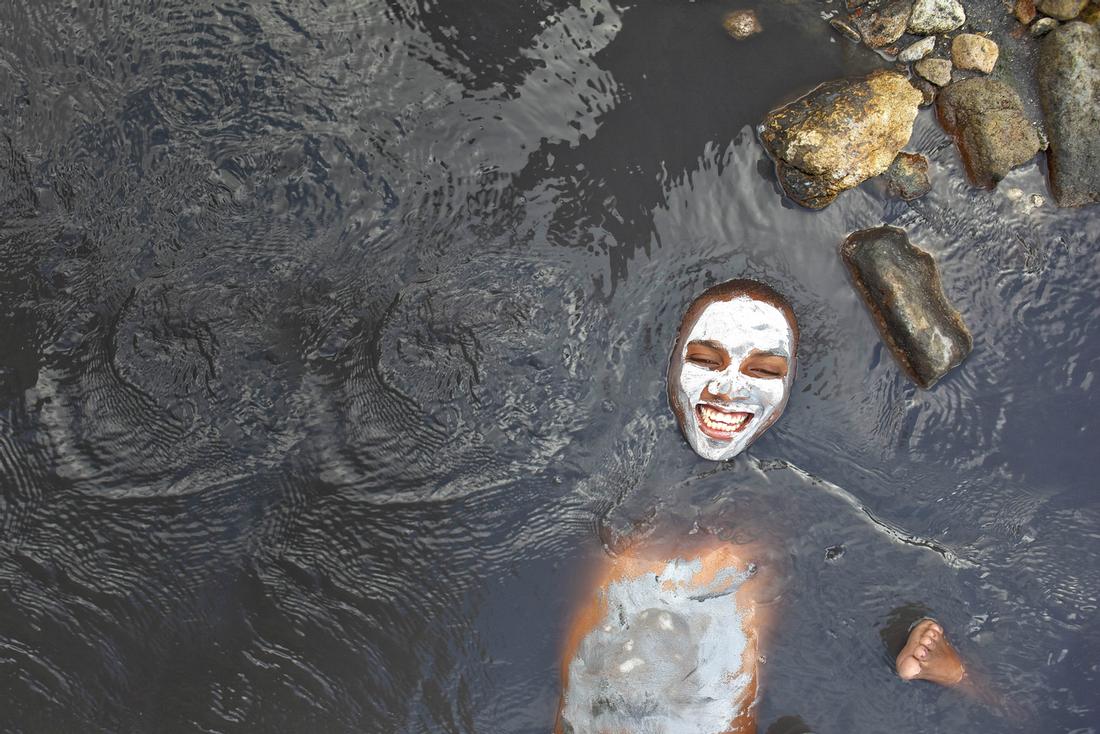 guest enjoying a dip in the mineral mud bath