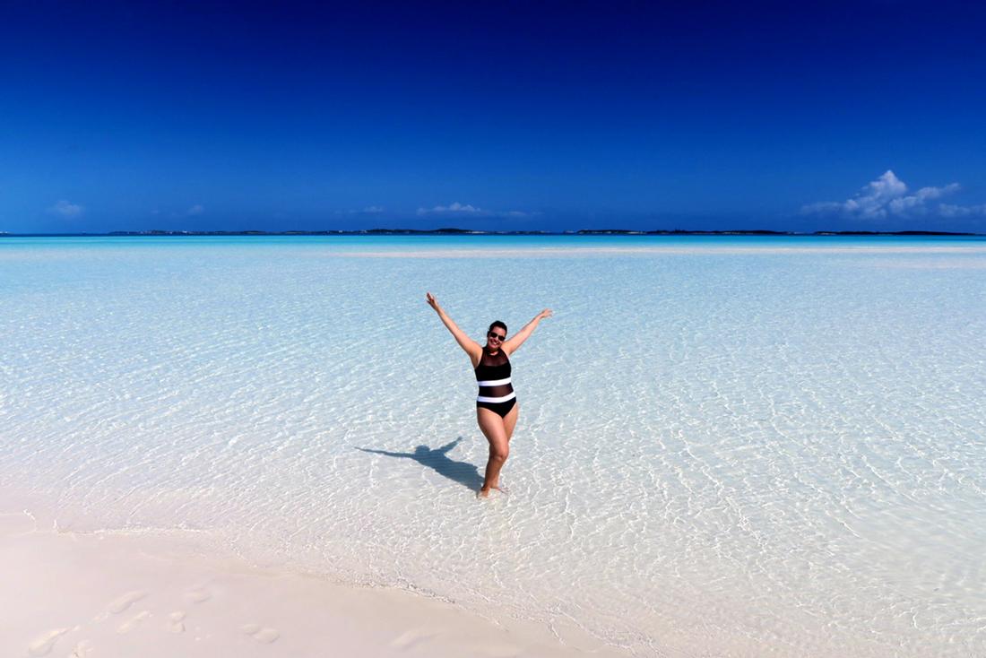 guest posing on the moriah harbor cay beach