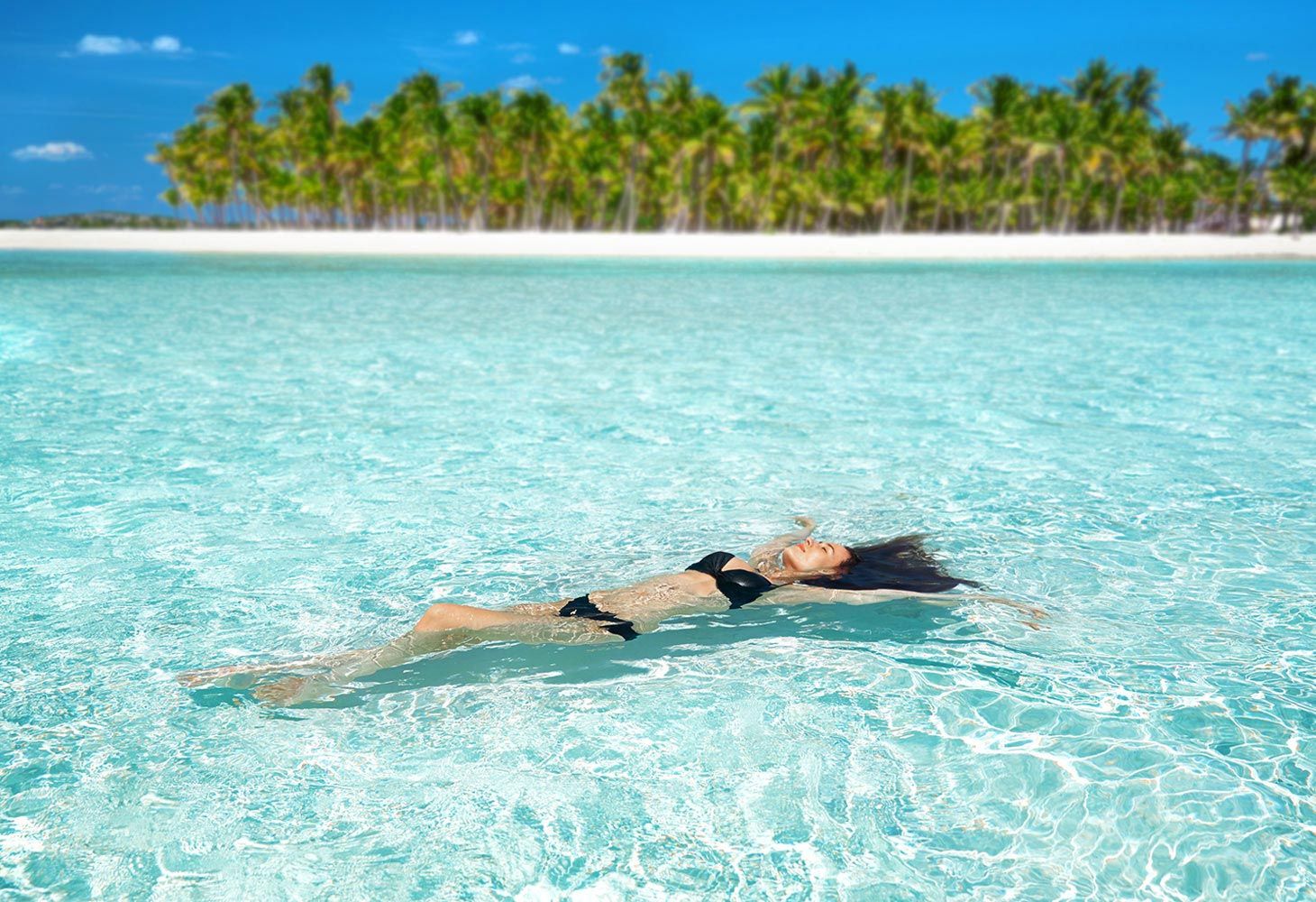 Woman Swimming At Sandals Emerald Bay Beach